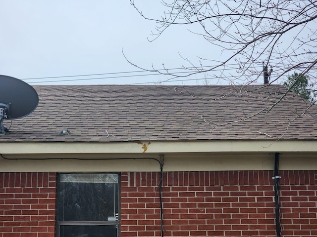 exterior details with brick siding and roof with shingles