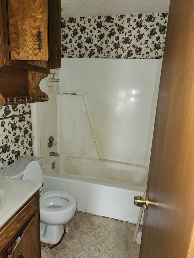 bathroom featuring vanity, shower / bathing tub combination, toilet, and tile patterned floors