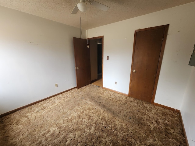 unfurnished bedroom with a closet, baseboards, a textured ceiling, and a ceiling fan