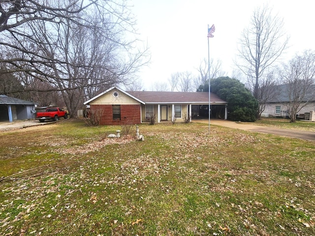 ranch-style house with a carport, brick siding, and driveway