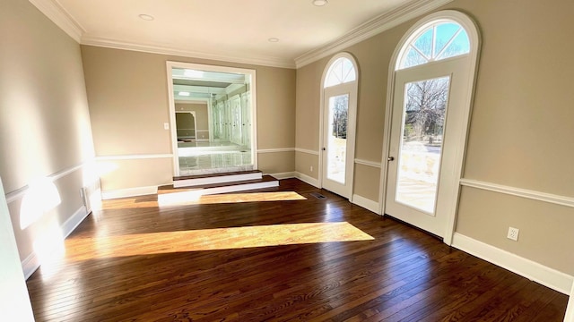 entryway featuring baseboards, hardwood / wood-style floors, and crown molding