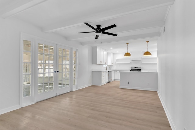 unfurnished living room featuring beamed ceiling, baseboards, light wood finished floors, and ceiling fan