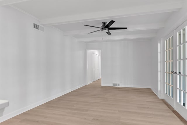 unfurnished room with light wood-type flooring, visible vents, beam ceiling, and baseboards