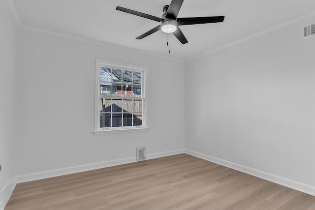 unfurnished room featuring a ceiling fan, crown molding, baseboards, and light wood-type flooring