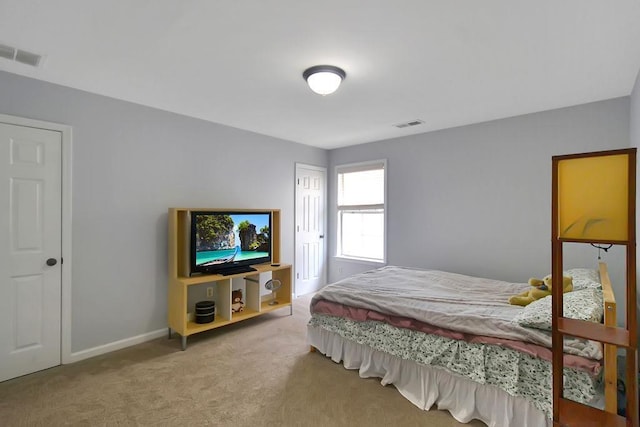 carpeted bedroom with visible vents and baseboards