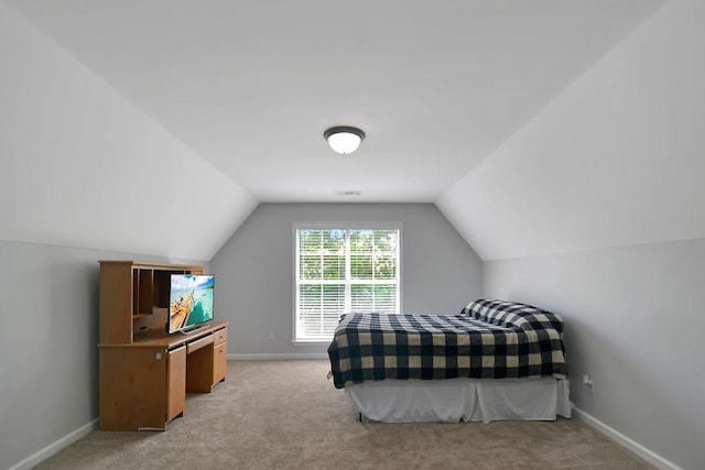 bedroom featuring light carpet, visible vents, baseboards, and lofted ceiling