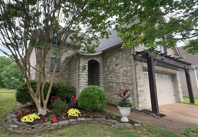 view of front of property with a garage, brick siding, and driveway