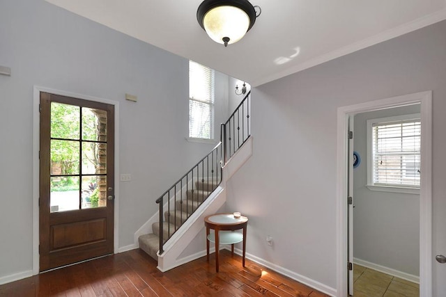 entrance foyer with stairs, baseboards, and wood-type flooring