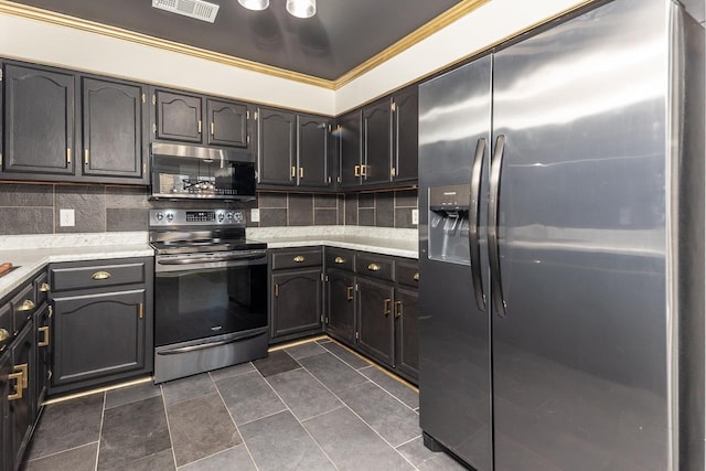 kitchen featuring tasteful backsplash, appliances with stainless steel finishes, and light countertops