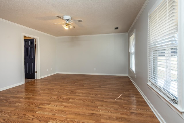 spare room featuring ornamental molding, a textured ceiling, a ceiling fan, and wood finished floors