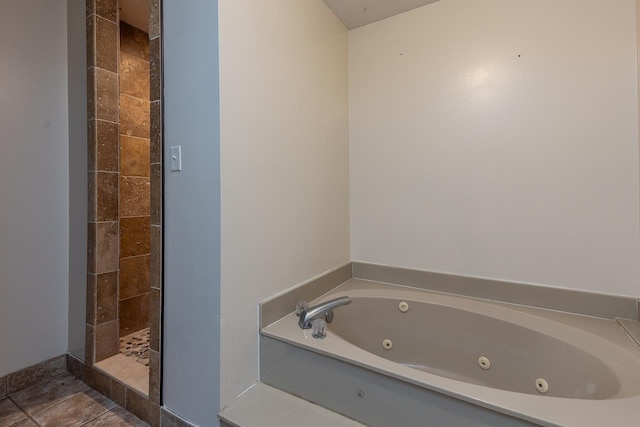 full bathroom with tile patterned floors, tiled shower, and a whirlpool tub