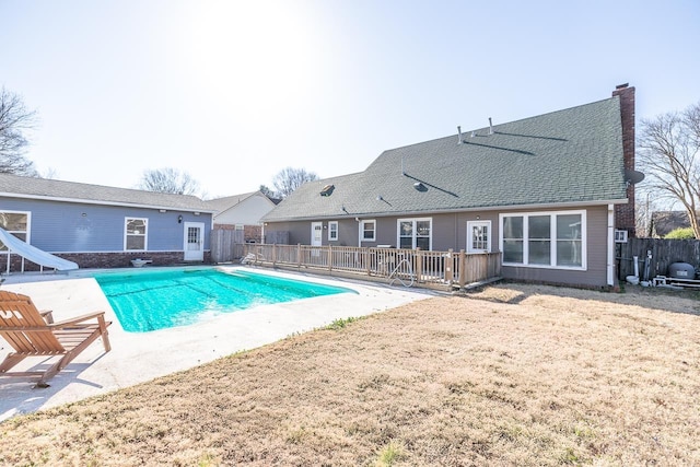 view of pool featuring a fenced in pool, a water slide, a patio, and fence