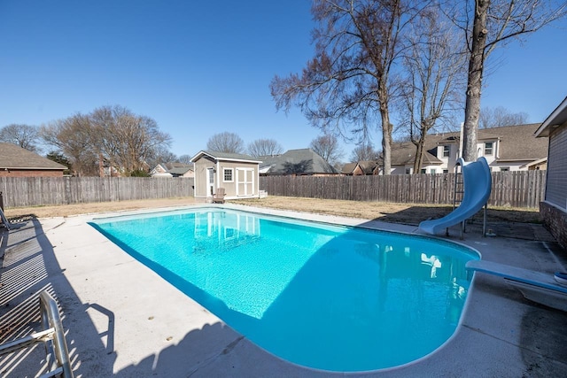 view of pool featuring a fenced in pool, a water slide, and a fenced backyard