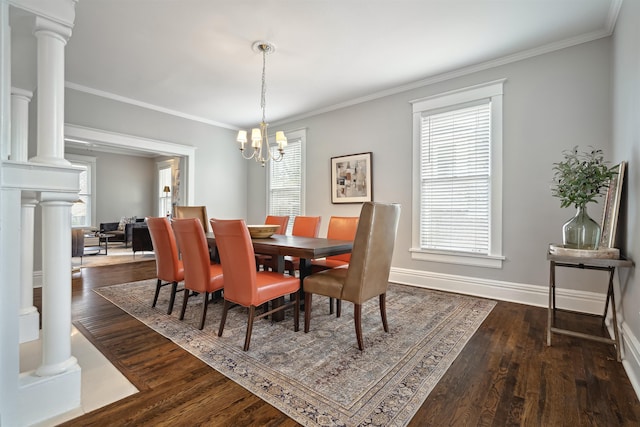 dining area with crown molding, dark wood-type flooring, baseboards, and decorative columns