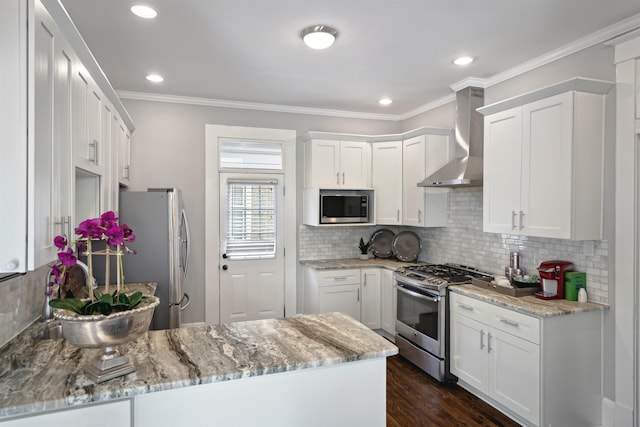 kitchen with tasteful backsplash, crown molding, wall chimney range hood, a peninsula, and stainless steel appliances