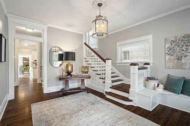 interior space featuring wood finished floors, stairway, crown molding, baseboards, and a chandelier