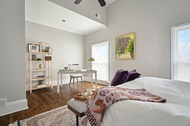 bedroom with ceiling fan, wood finished floors, visible vents, and baseboards