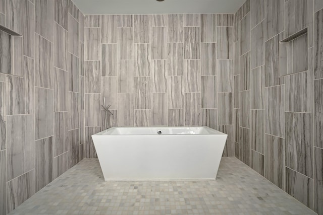 full bathroom with a freestanding tub and a tile shower