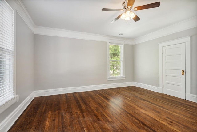 spare room with dark wood-style floors, baseboards, and ornamental molding