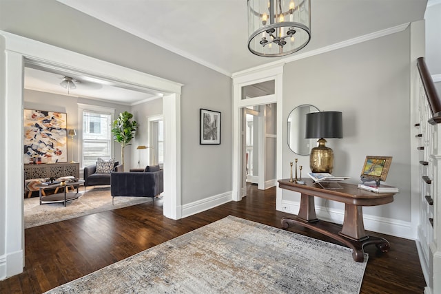 entrance foyer with a notable chandelier, wood finished floors, baseboards, and ornamental molding