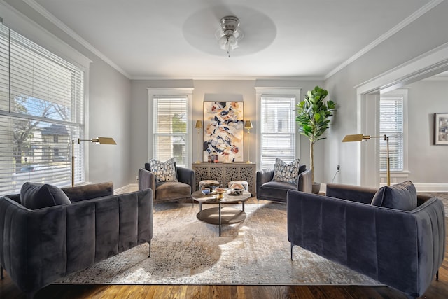 living room featuring crown molding, wood finished floors, baseboards, and ceiling fan