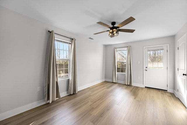 interior space featuring visible vents, ceiling fan, baseboards, and light wood-style floors