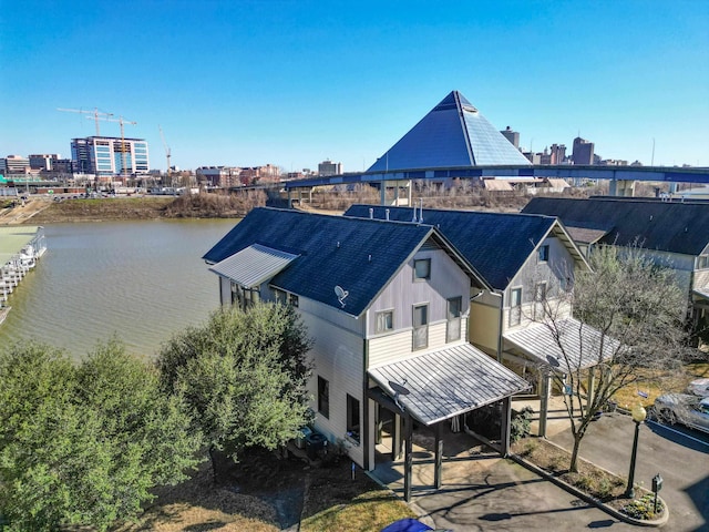 birds eye view of property with a view of city and a water view