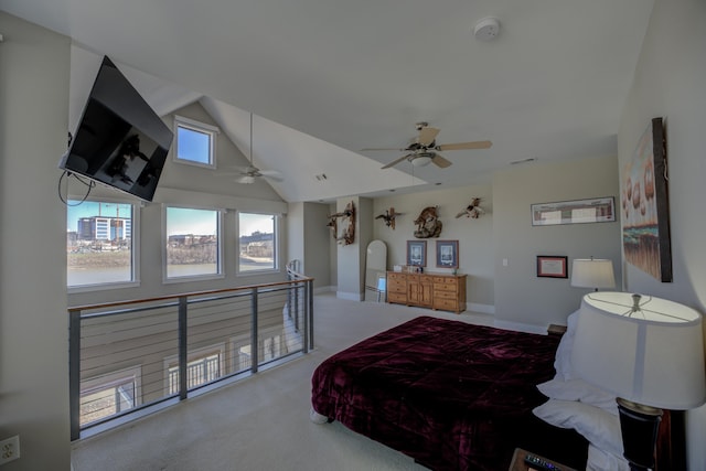 carpeted bedroom with vaulted ceiling, baseboards, and ceiling fan