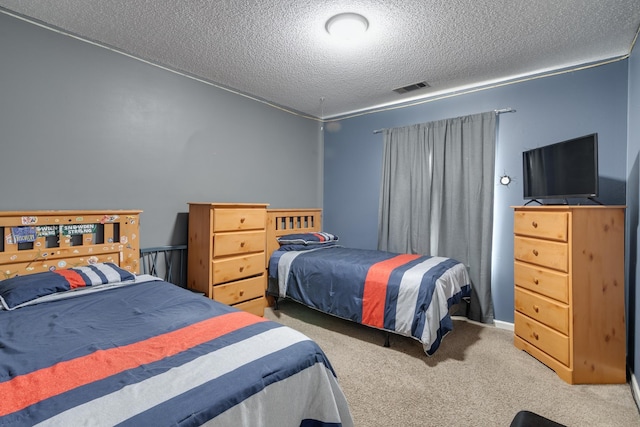 carpeted bedroom featuring visible vents and a textured ceiling