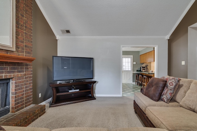 living area with visible vents, a fireplace, carpet flooring, and ornamental molding