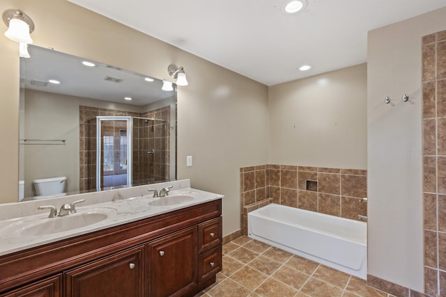 bathroom featuring tile patterned flooring, a shower stall, toilet, and a sink