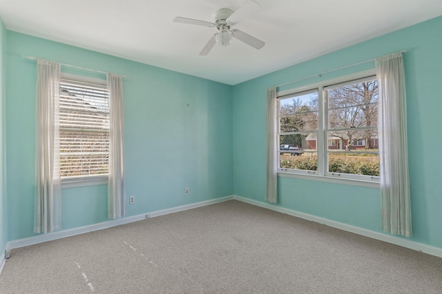 carpeted empty room with baseboards and ceiling fan