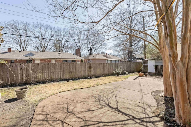 view of patio / terrace featuring an outbuilding, a storage shed, and a fenced backyard