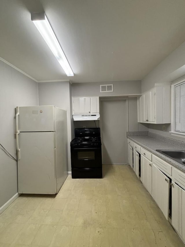 kitchen featuring black range with gas cooktop, visible vents, white cabinetry, and freestanding refrigerator