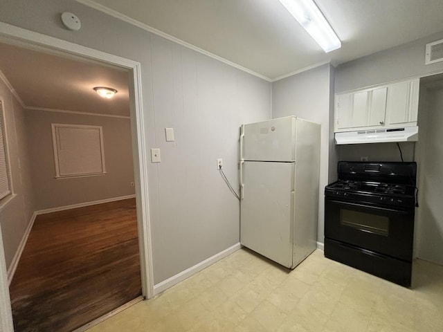 kitchen with under cabinet range hood, white cabinetry, freestanding refrigerator, light floors, and black range with gas cooktop