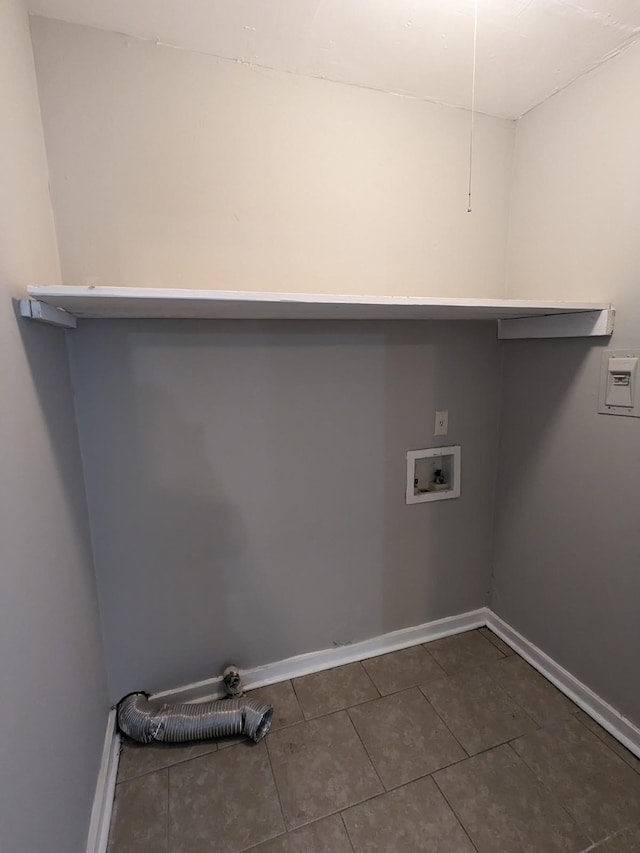 laundry area featuring laundry area, hookup for a washing machine, dark tile patterned floors, and baseboards