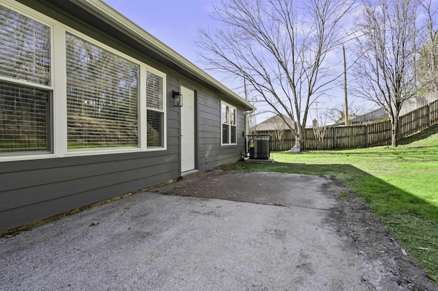 view of patio / terrace featuring central air condition unit and fence