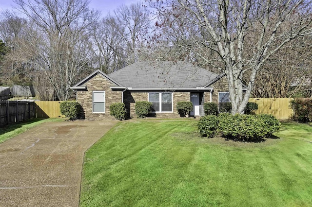 ranch-style house with brick siding, concrete driveway, a front yard, and fence