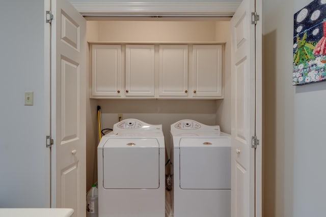 laundry room featuring cabinet space and separate washer and dryer