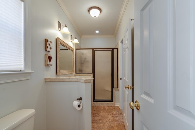 bathroom with toilet, a stall shower, and crown molding