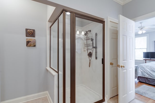 ensuite bathroom featuring connected bathroom, baseboards, and a stall shower