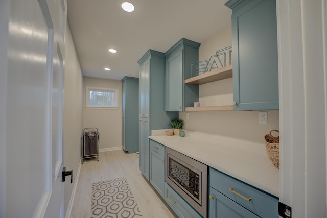 kitchen with open shelves, baseboards, light countertops, recessed lighting, and green cabinetry