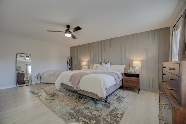 bedroom with baseboards, light wood-style floors, and ceiling fan