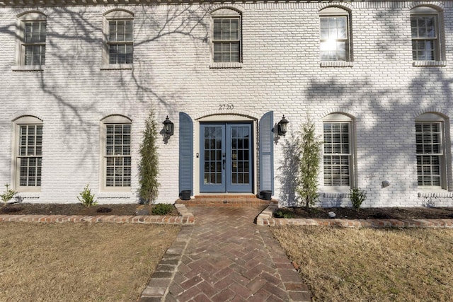 entrance to property with french doors and brick siding