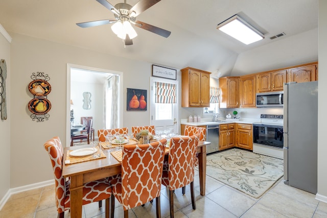 kitchen featuring visible vents, light countertops, lofted ceiling, appliances with stainless steel finishes, and a sink