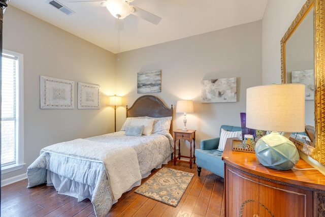 bedroom featuring visible vents, wood-type flooring, and multiple windows