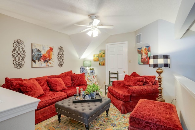 living area with visible vents, lofted ceiling, and a ceiling fan