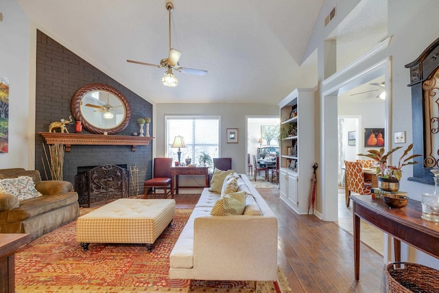 living room featuring a ceiling fan, visible vents, lofted ceiling, a fireplace, and wood-type flooring