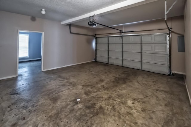 garage with a garage door opener and baseboards