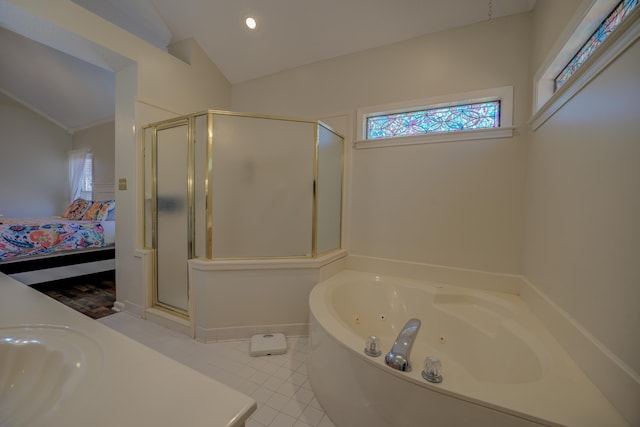 ensuite bathroom featuring plenty of natural light, a shower stall, ensuite bath, and vaulted ceiling